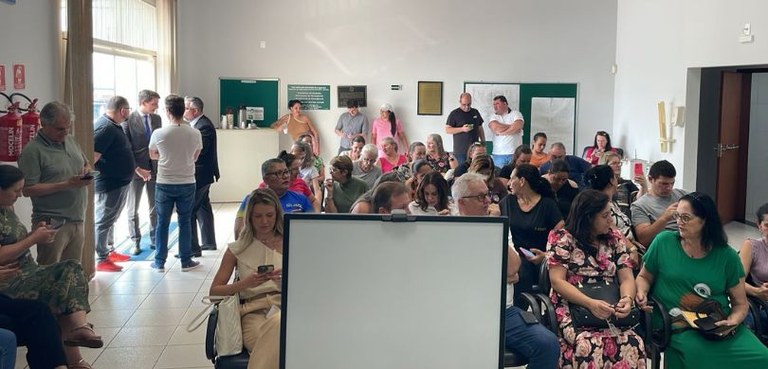 Foto em que aparecem dezenas de pessoas sentadas e outras em pé no Fórum Eleitoral de Palotina. ...